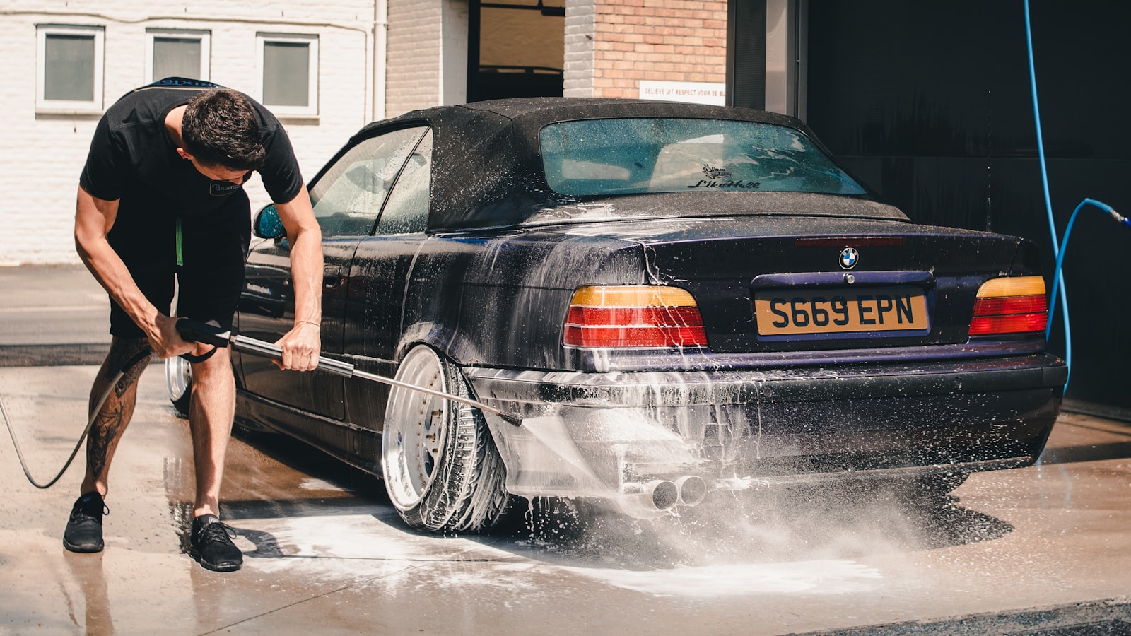 A clean car with water beading on its freshly washed paintwork.